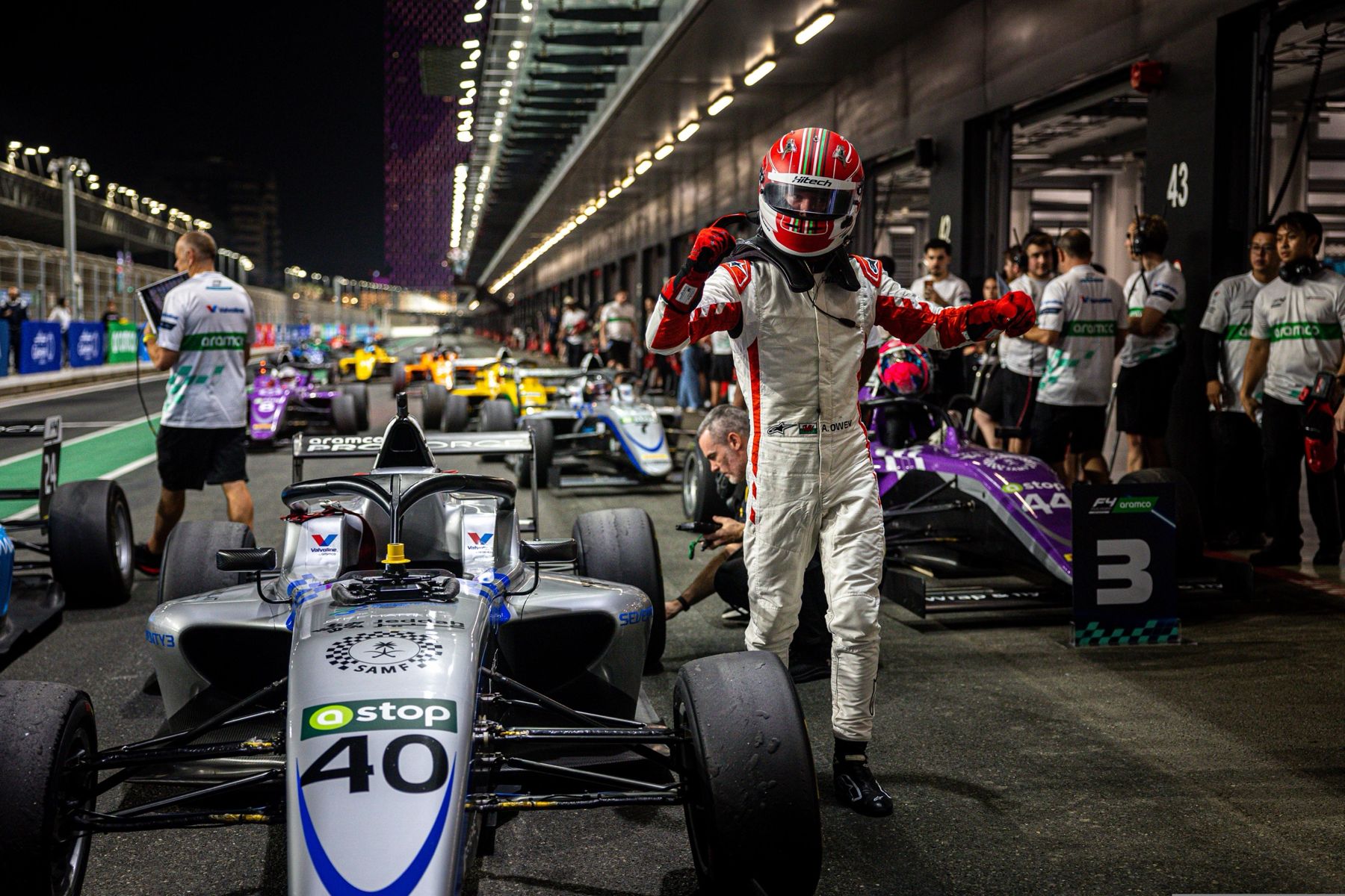 Archie Owen celebrating beside his #40 car in the Jeddah pit lane